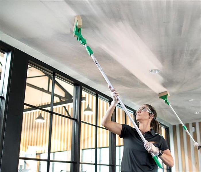 Servpro Employees Cleaning a Ceiling
